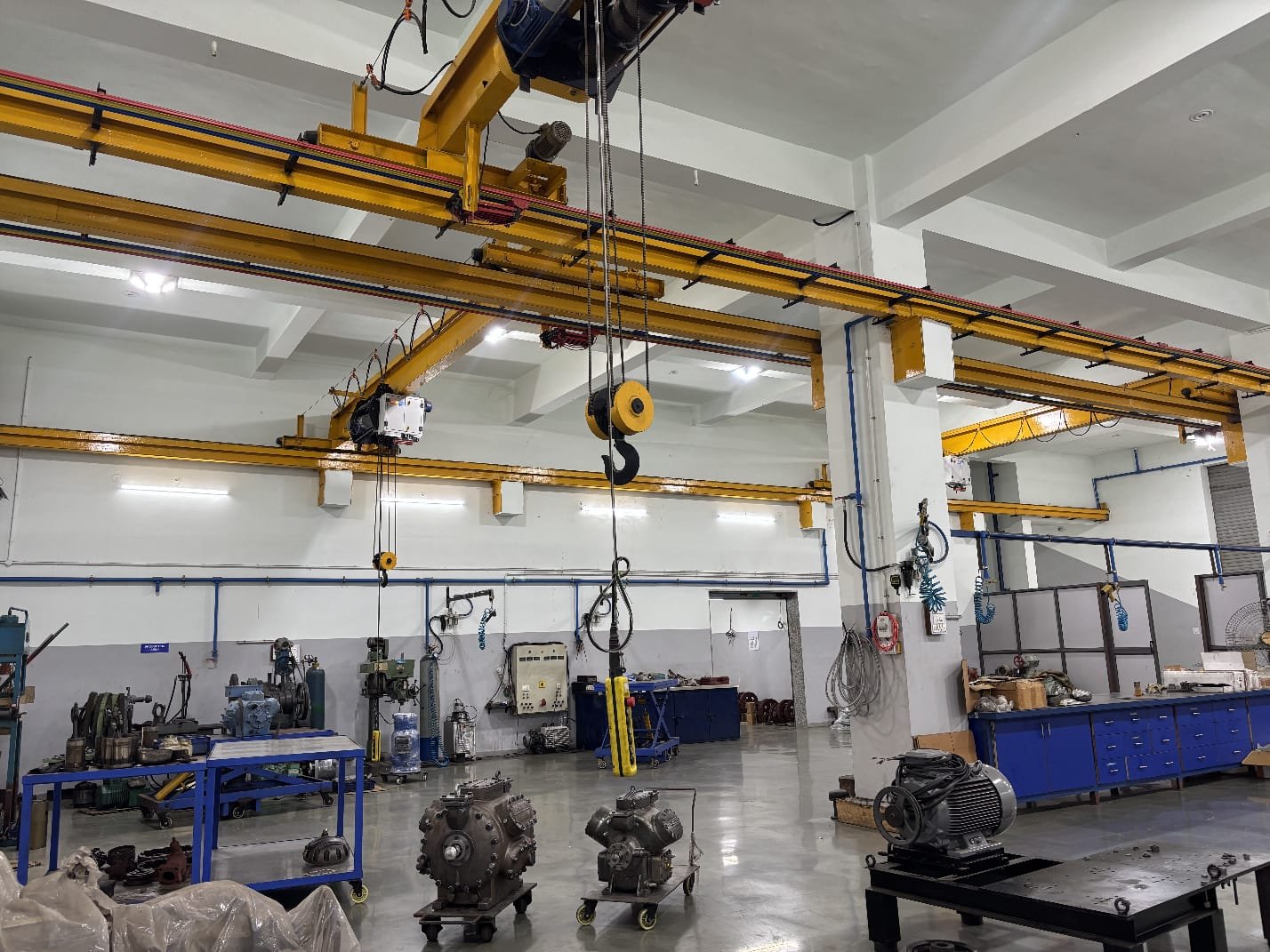 Workshop wide shot — machinist working on compressor